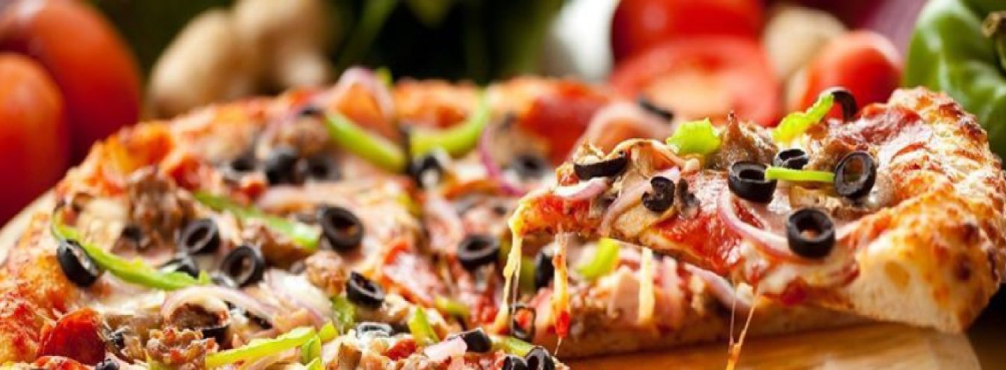 cheese pizza topped with peppers and black olives